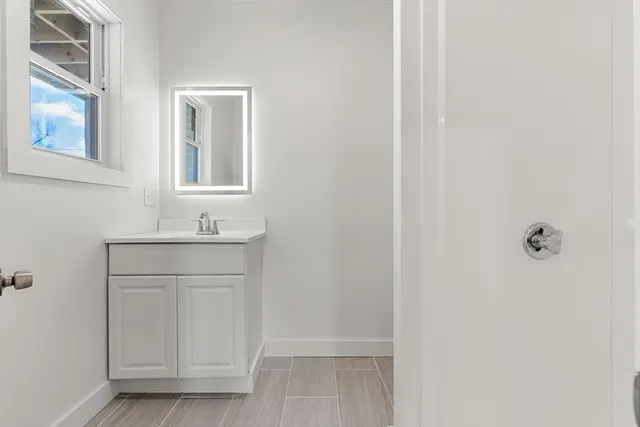 a bathroom with a sink a vanity and a mirror