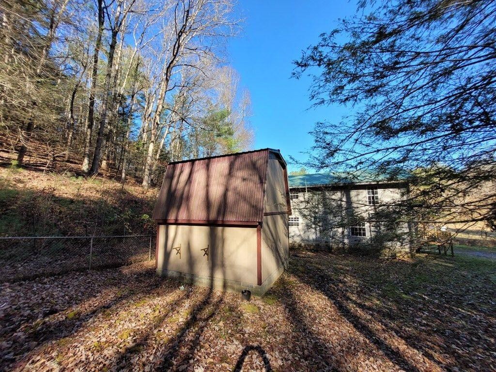 145 Crawford Stiles Road Farner, TN 37333 - Photo 21 of 45 a backyard of a house with lots of green space