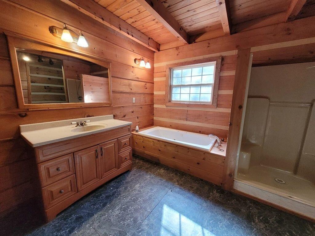 145 Crawford Stiles Road Farner, TN 37333 - Photo 10 of 45 a bathroom with a double vanity sink a mirror and a bathtub