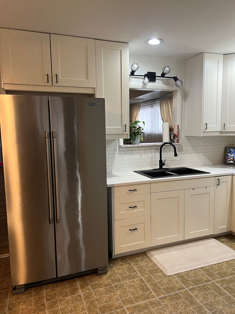 1170 Westview Drive Rochelle, IL 61068 - Photo 3 of 12 a kitchen with stainless steel appliances granite countertop a refrigerator a sink and white cabinets