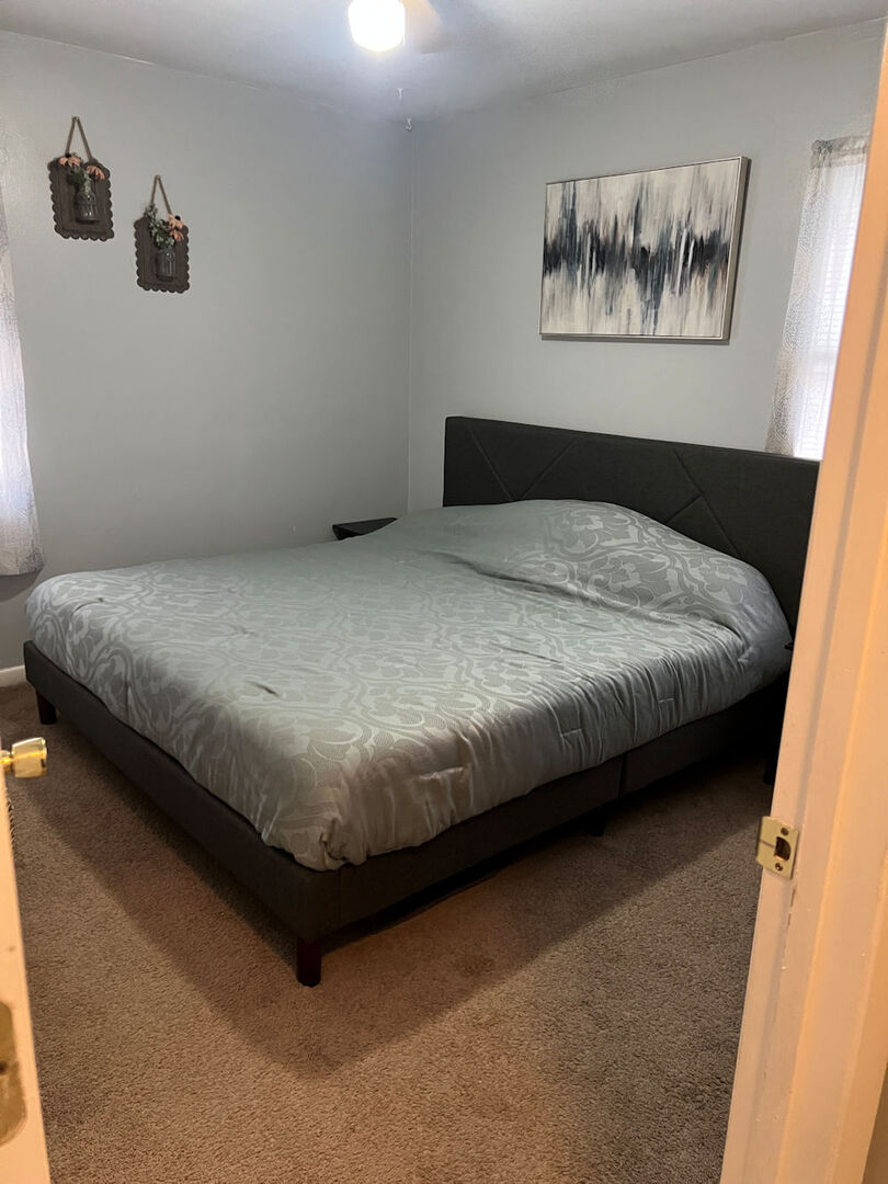 1170 Westview Drive Rochelle, IL 61068 - Photo 7 of 12 a bedroom with a bed and wall painting on the wall