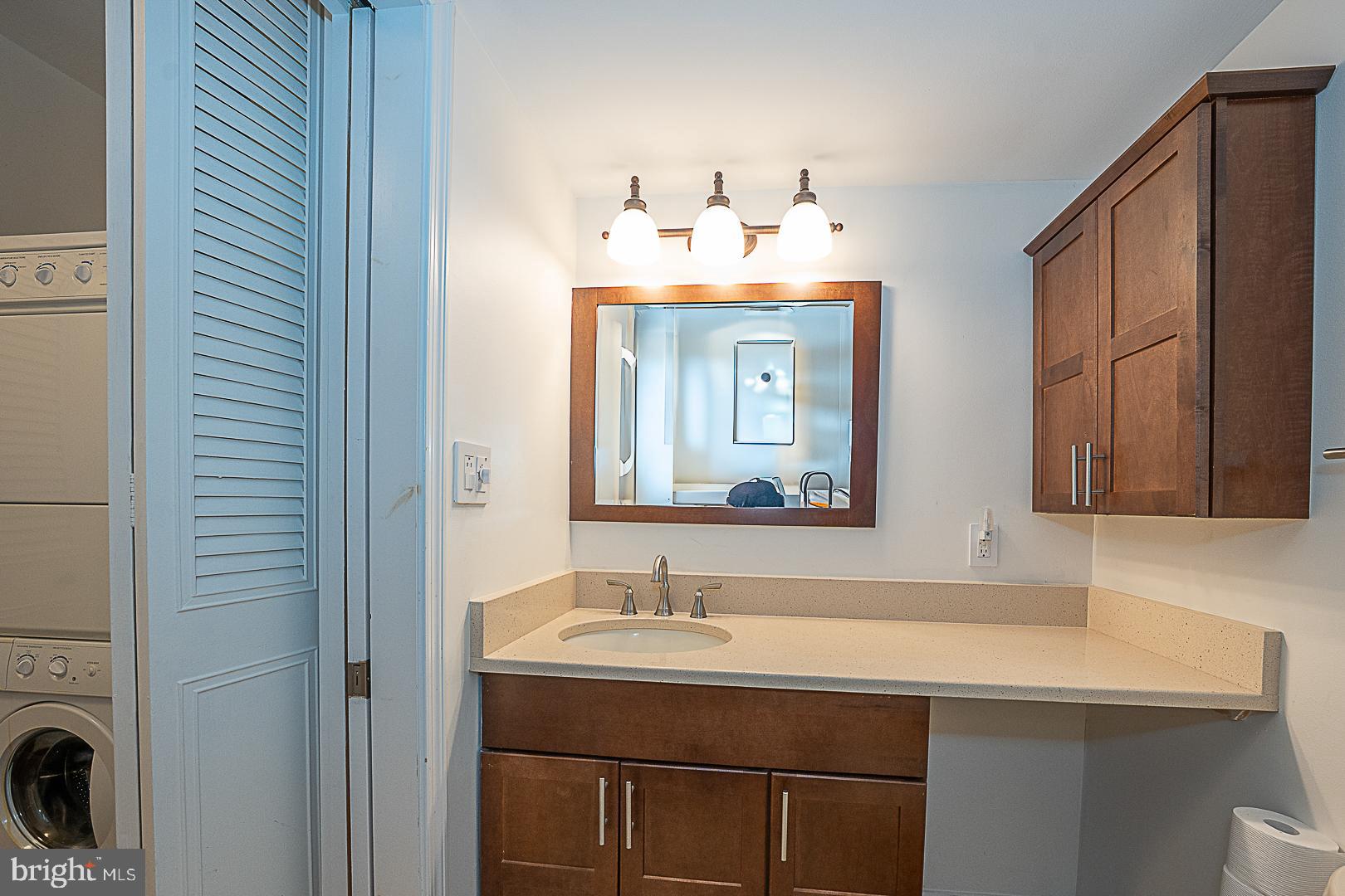 1919 Chestnut Street, Unit 1722 Philadelphia, PA 19103 - Photo 13 of 26 a bathroom with a sink and a mirror
