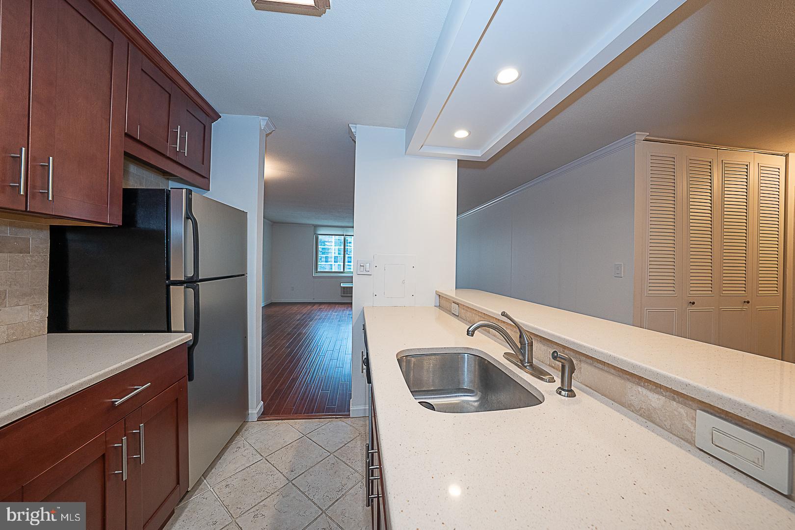 1919 Chestnut Street, Unit 1722 Philadelphia, PA 19103 - Photo 6 of 26 a kitchen with stainless steel appliances granite countertop a refrigerator a sink and a stove