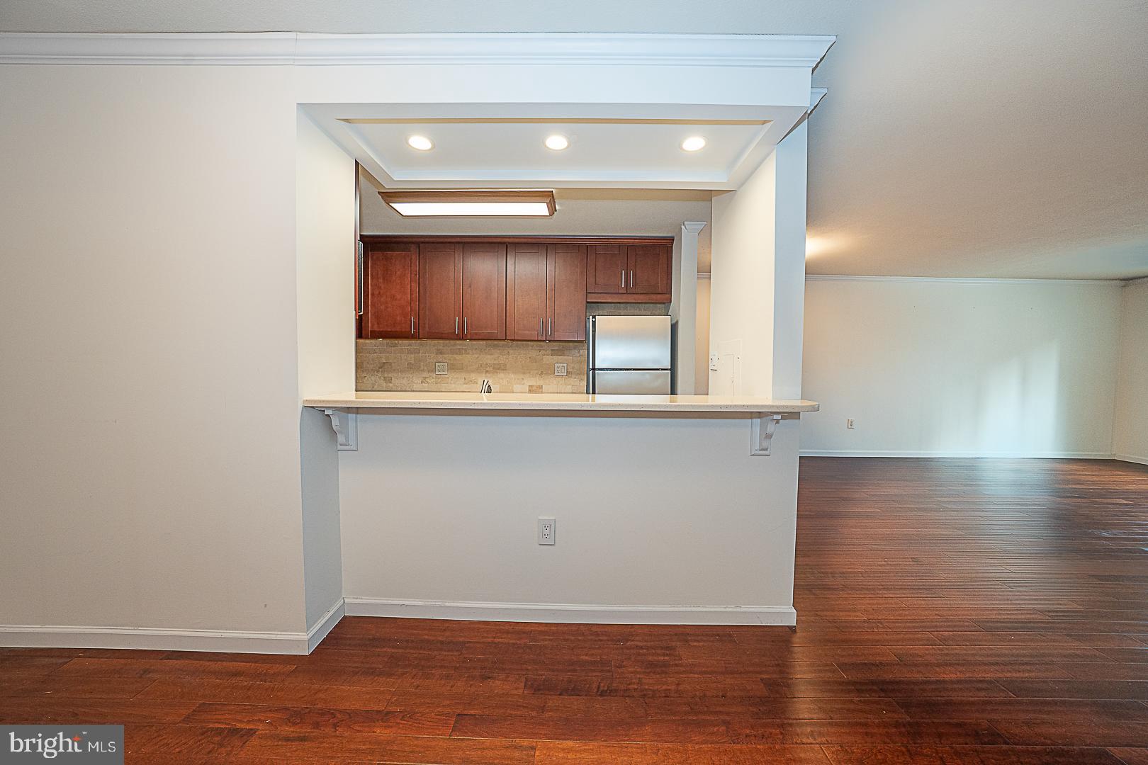 1919 Chestnut Street, Unit 1722 Philadelphia, PA 19103 - Photo 8 of 26 a view of an empty room with wooden floor and a window