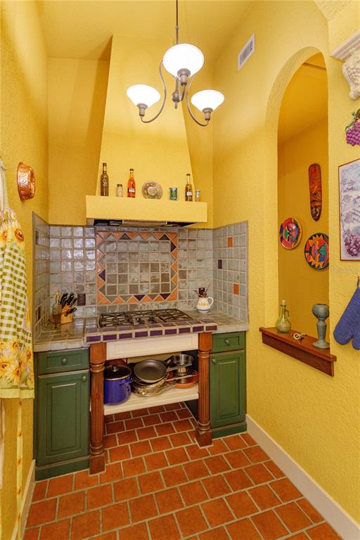 24540 Turkey Lake Road Howey-in-the-Hills, FL 34737 - Photo 11 of 42 a kitchen with a sink and a stove