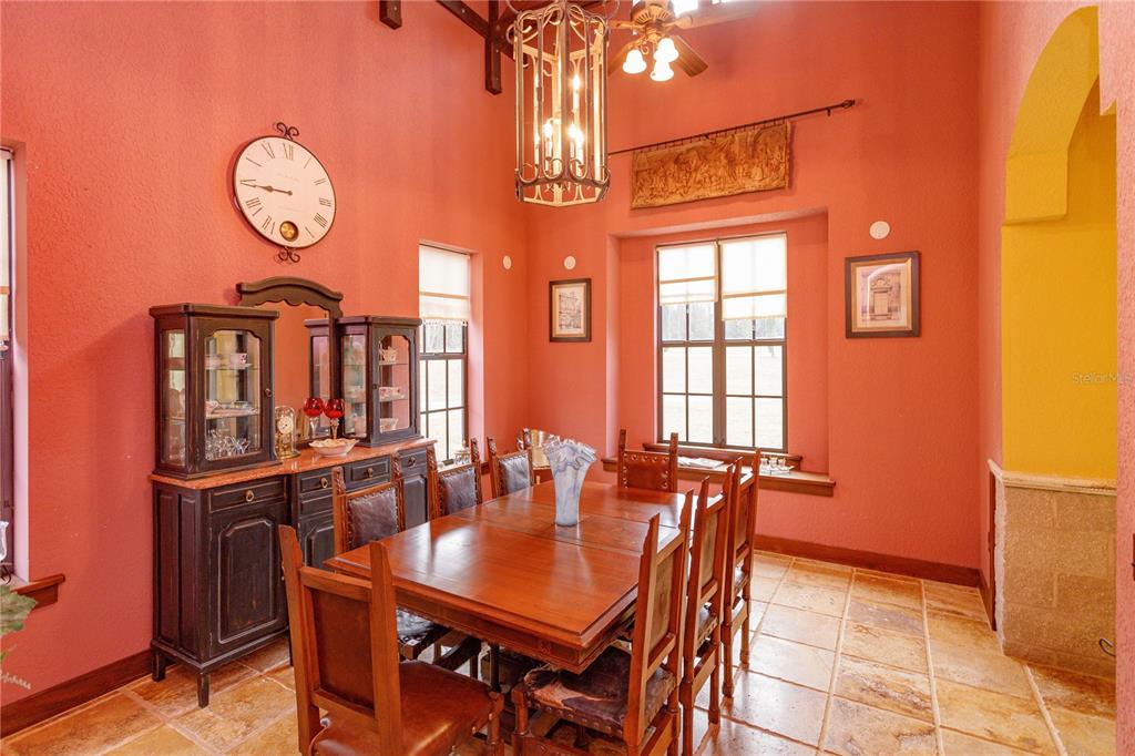24540 Turkey Lake Road Howey-in-the-Hills, FL 34737 - Photo 14 of 42 a view of a dining room with furniture window and wooden floor