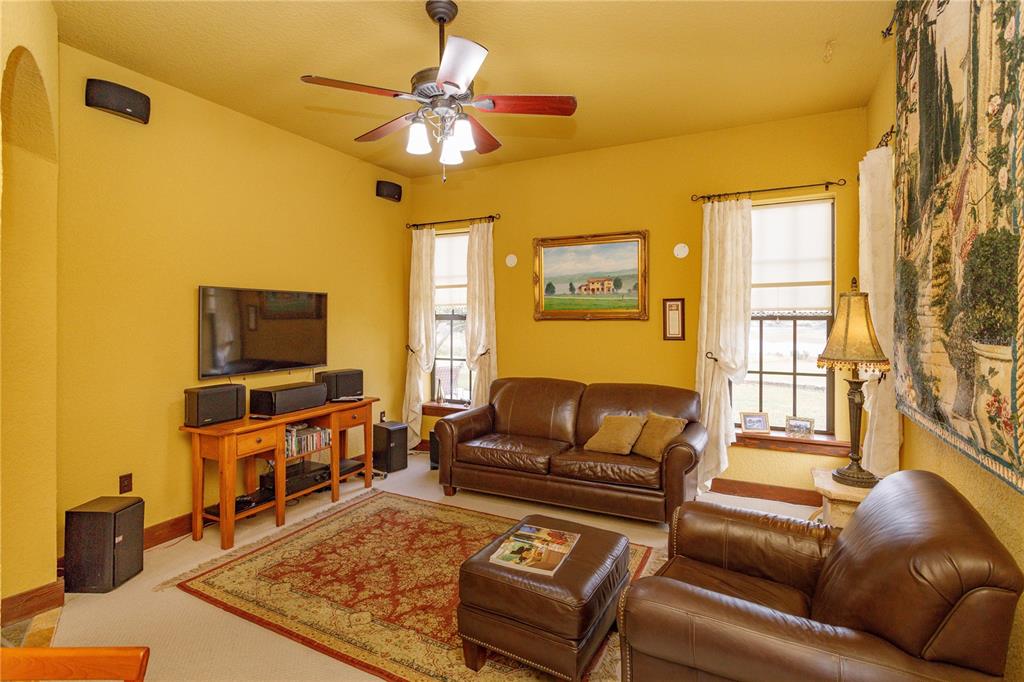 24540 Turkey Lake Road Howey-in-the-Hills, FL 34737 - Photo 16 of 42 a living room with furniture and a flat screen tv