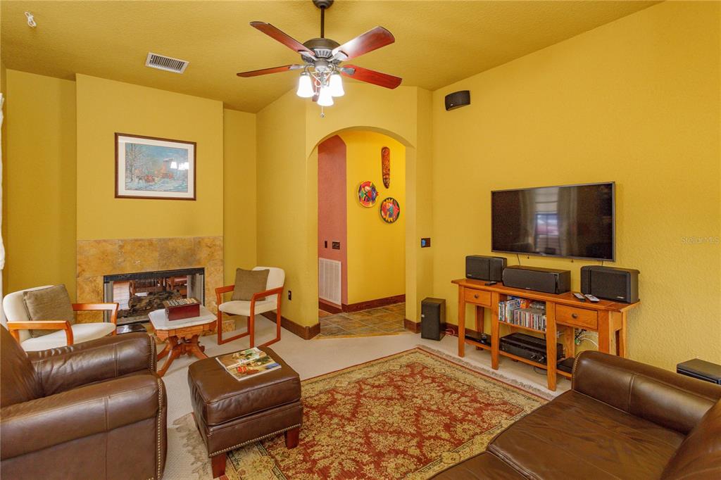 24540 Turkey Lake Road Howey-in-the-Hills, FL 34737 - Photo 17 of 42 a living room with furniture and a flat screen tv