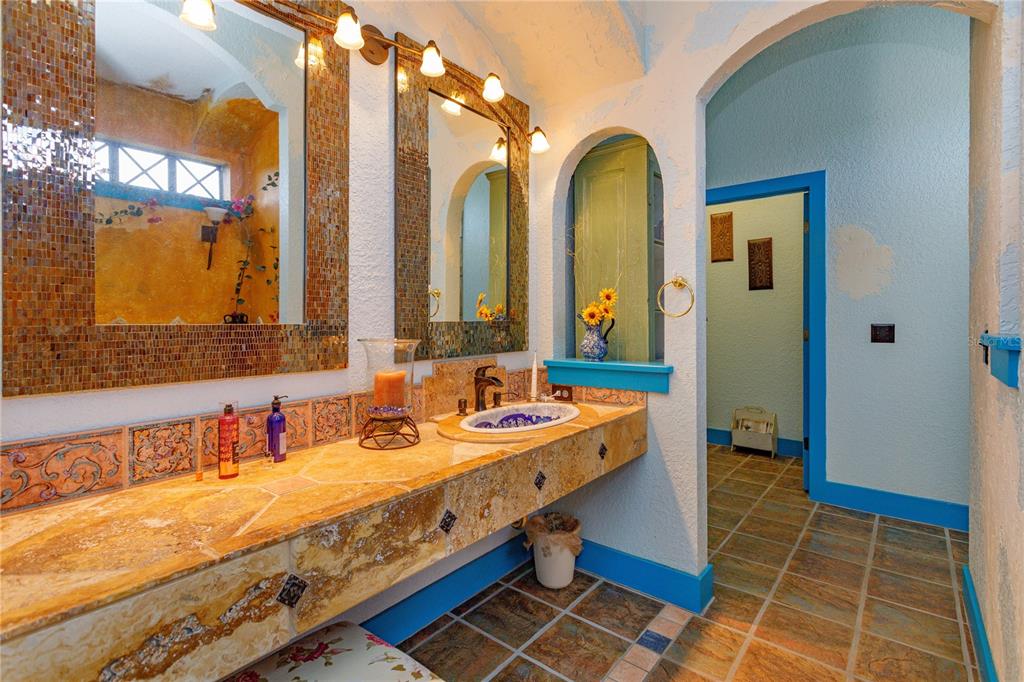 24540 Turkey Lake Road Howey-in-the-Hills, FL 34737 - Photo 20 of 42 a bathroom with a granite countertop sink and a mirror