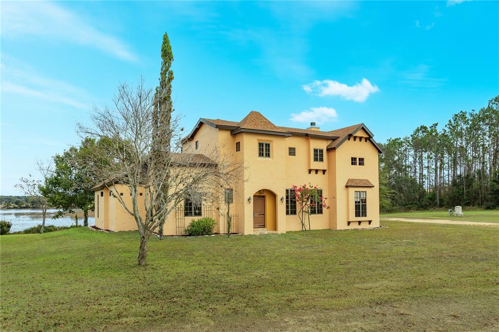 24540 Turkey Lake Road Howey-in-the-Hills, FL 34737 - Photo 2 of 42 a view of a house with a backyard
