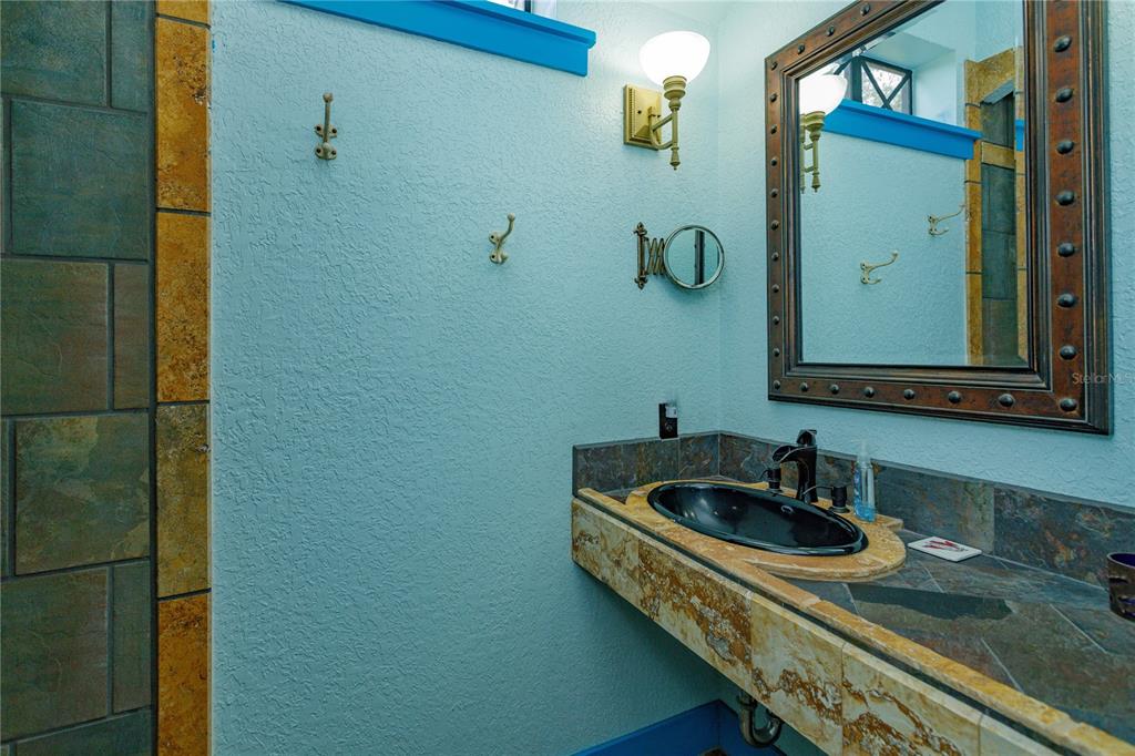 24540 Turkey Lake Road Howey-in-the-Hills, FL 34737 - Photo 21 of 42 a bathroom with a sink and a mirror