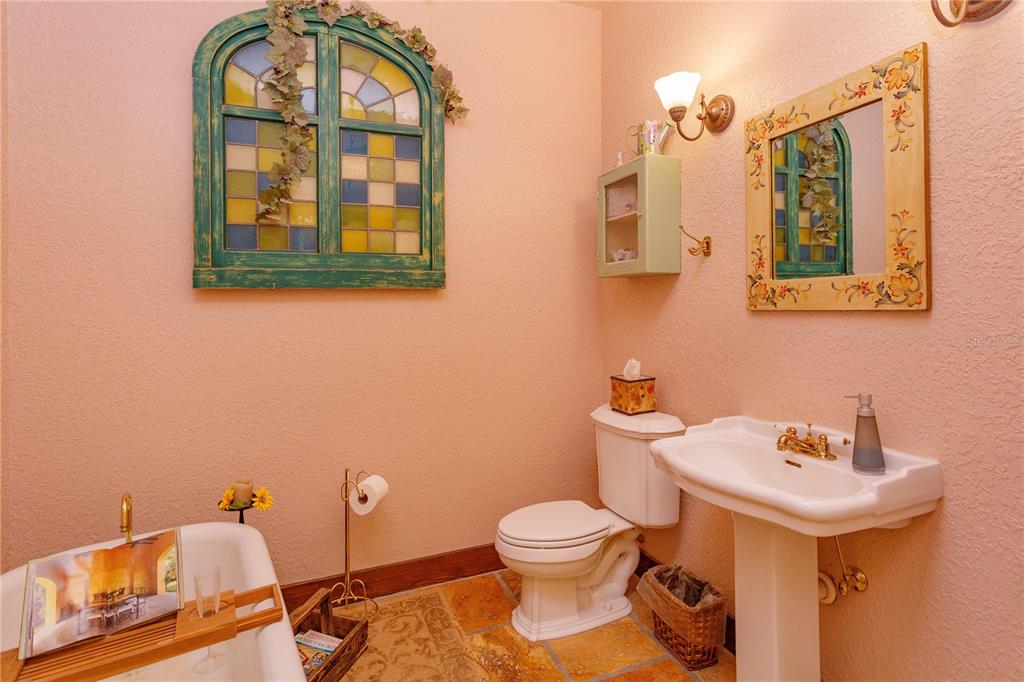 24540 Turkey Lake Road Howey-in-the-Hills, FL 34737 - Photo 25 of 42 a bathroom with a toilet sink and mirror