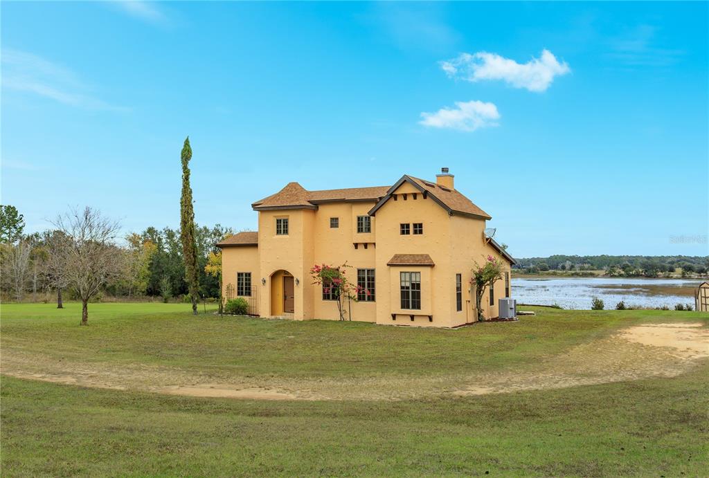 24540 Turkey Lake Road Howey-in-the-Hills, FL 34737 - Photo 3 of 42 a view of a house with a yard