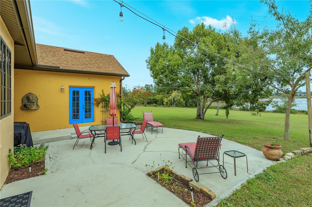 24540 Turkey Lake Road Howey-in-the-Hills, FL 34737 - Photo 33 of 42 an outdoor view of a garden with patio