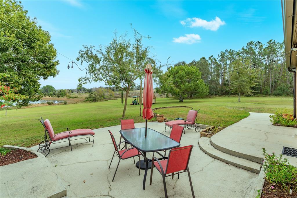 24540 Turkey Lake Road Howey-in-the-Hills, FL 34737 - Photo 34 of 42 a view of a patio with furniture and garden