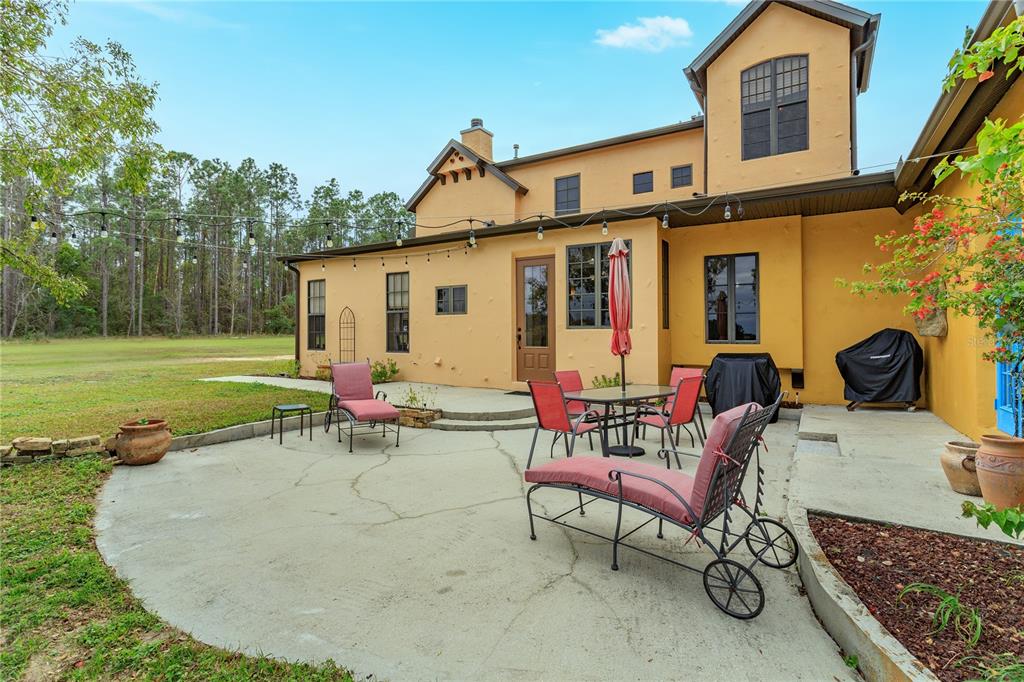24540 Turkey Lake Road Howey-in-the-Hills, FL 34737 - Photo 35 of 42 a view of a house with backyard and a sitting area