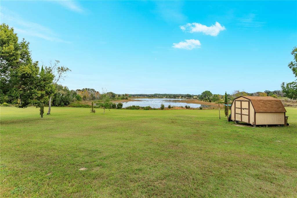 24540 Turkey Lake Road Howey-in-the-Hills, FL 34737 - Photo 39 of 42 a view of a large building with garden in front of it