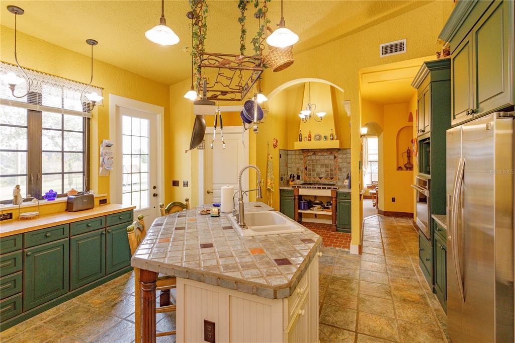 24540 Turkey Lake Road Howey-in-the-Hills, FL 34737 - Photo 9 of 42 a large kitchen with a table and chairs