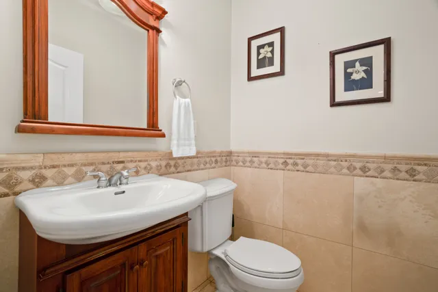 a bathroom with a sink mirror vanity and toilet