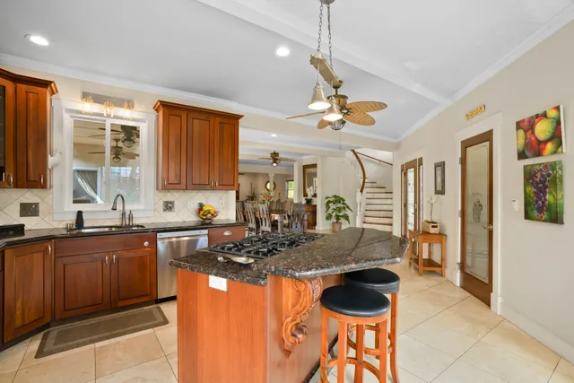 a kitchen with stainless steel appliances granite countertop a stove a sink and a refrigerator
