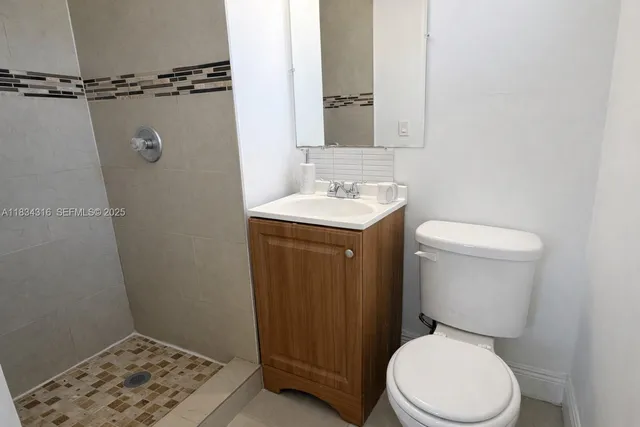 a view of backyard with potted plants and a large tree