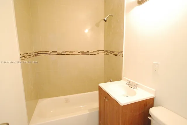 a bathroom with a sink a toilet and tub