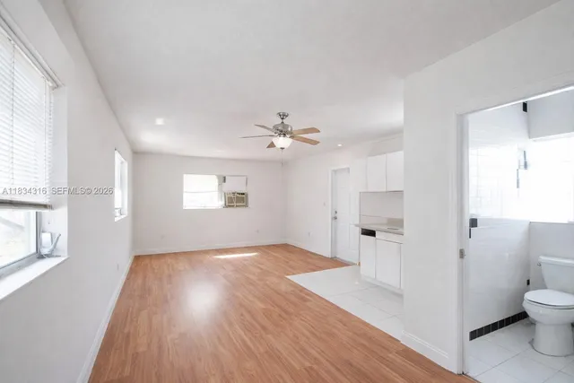 a bathroom with a toilet a sink a bath tub and a window