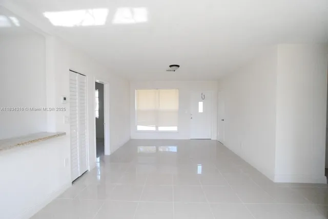 a view of an empty room and window