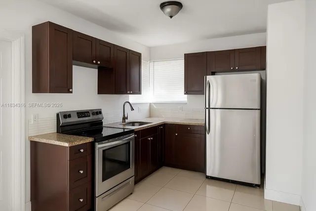 a kitchen with a refrigerator stove and microwave