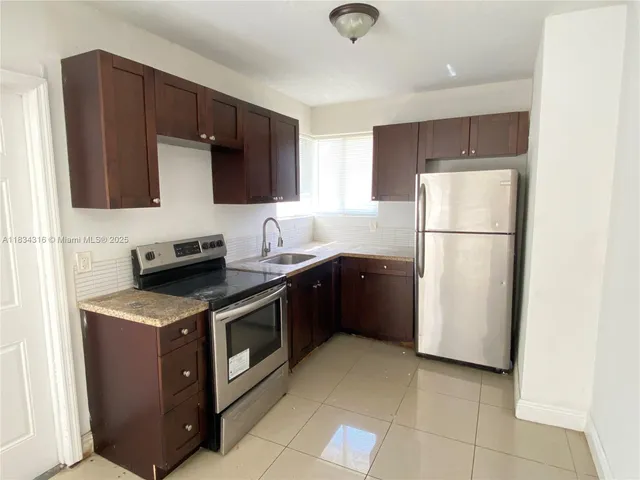 a kitchen with a refrigerator stove and microwave