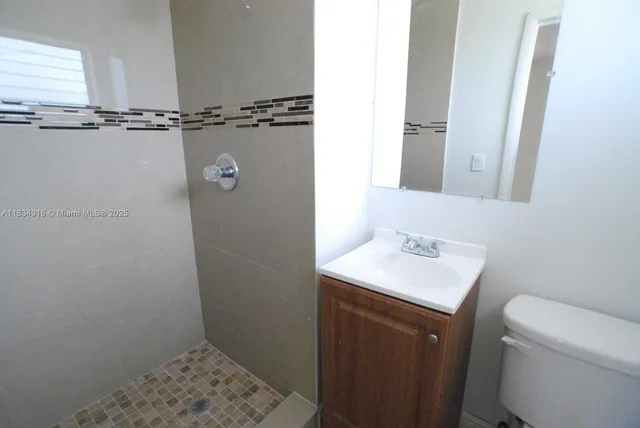 a bathroom with a sink toilet and vanity