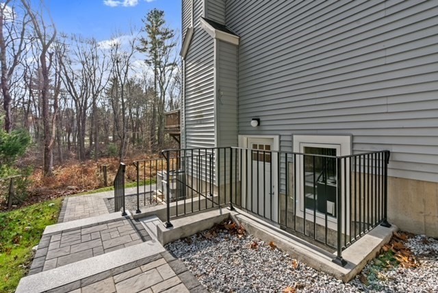 80 Emer Road, Unit 1 Marlborough, MA 01752 - Photo 2 of 11 a view of a brick house with a small garden