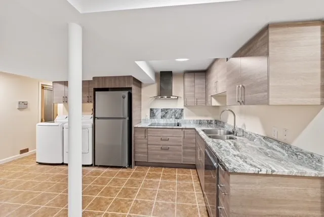 a kitchen with a refrigerator sink and cabinets