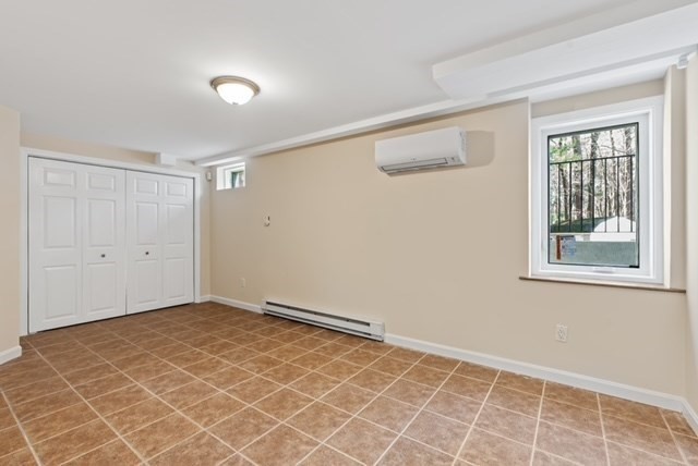 80 Emer Road, Unit 1 Marlborough, MA 01752 - Photo 8 of 11 an empty room with a empty space and windows