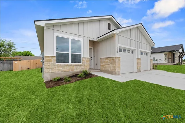 a view of house with backyard