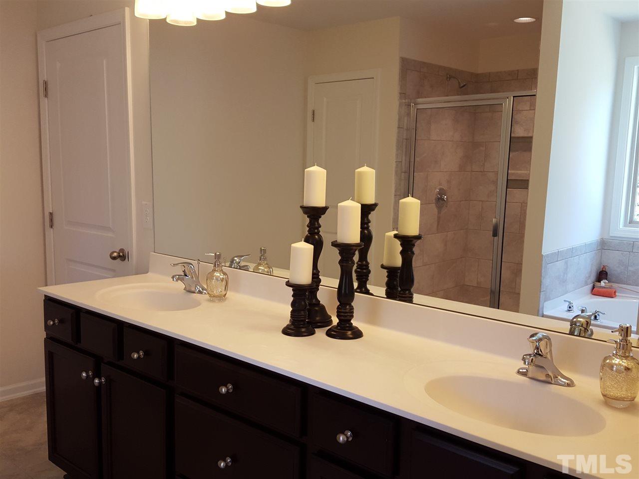 7524 Channery Way Raleigh, NC 27616 - Photo 12 of 25 a bathroom with a sink and a mirror