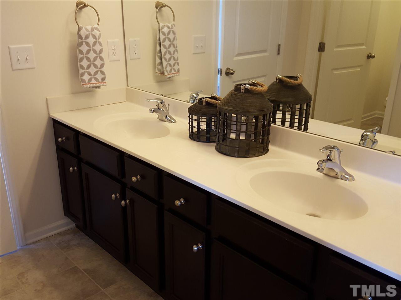 7524 Channery Way Raleigh, NC 27616 - Photo 17 of 25 a bathroom with a sink and a mirror