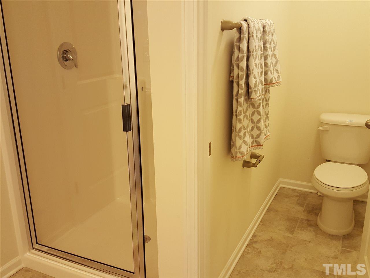 7524 Channery Way Raleigh, NC 27616 - Photo 18 of 25 a bathroom with a toilet and shower