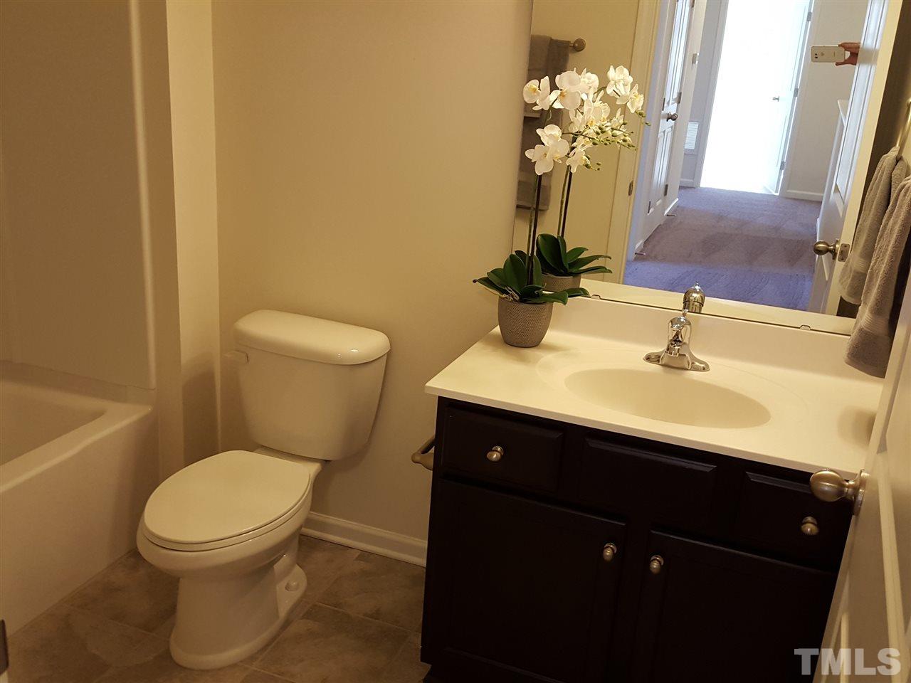 7524 Channery Way Raleigh, NC 27616 - Photo 20 of 25 a bathroom with a toilet sink and mirror