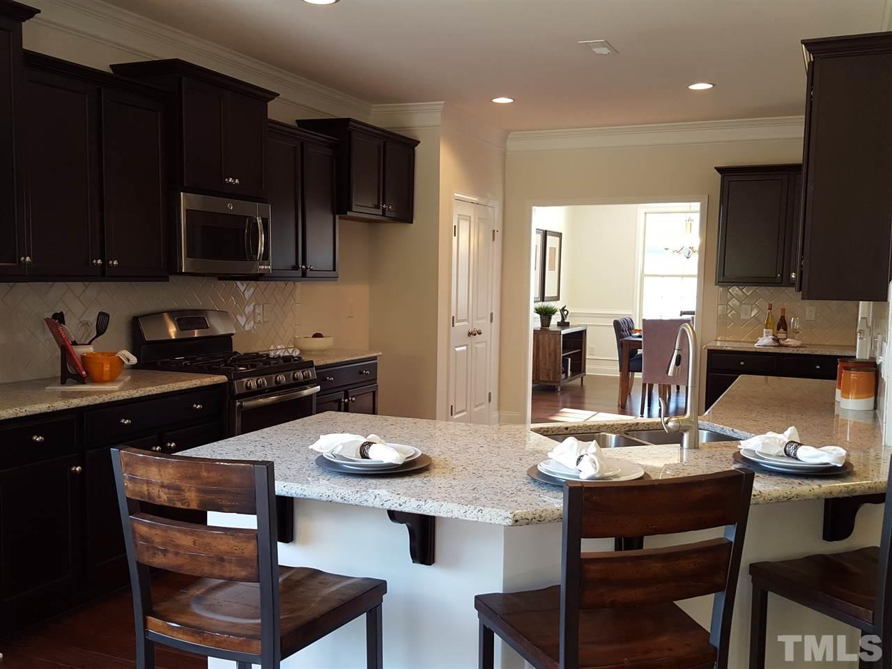 7524 Channery Way Raleigh, NC 27616 - Photo 5 of 25 a kitchen with a dining table and chairs
