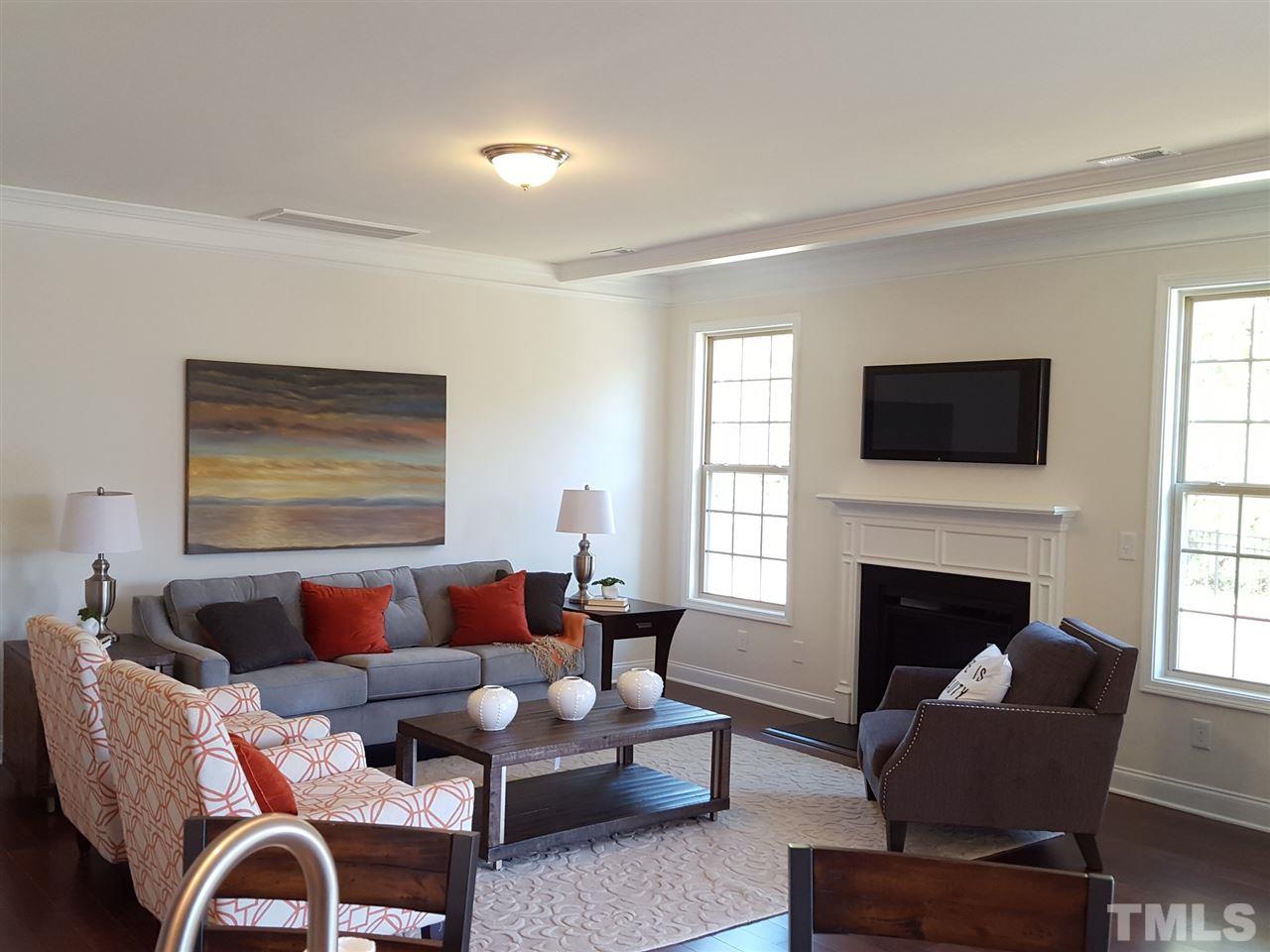 7524 Channery Way Raleigh, NC 27616 - Photo 6 of 25 a living room with furniture fireplace and window