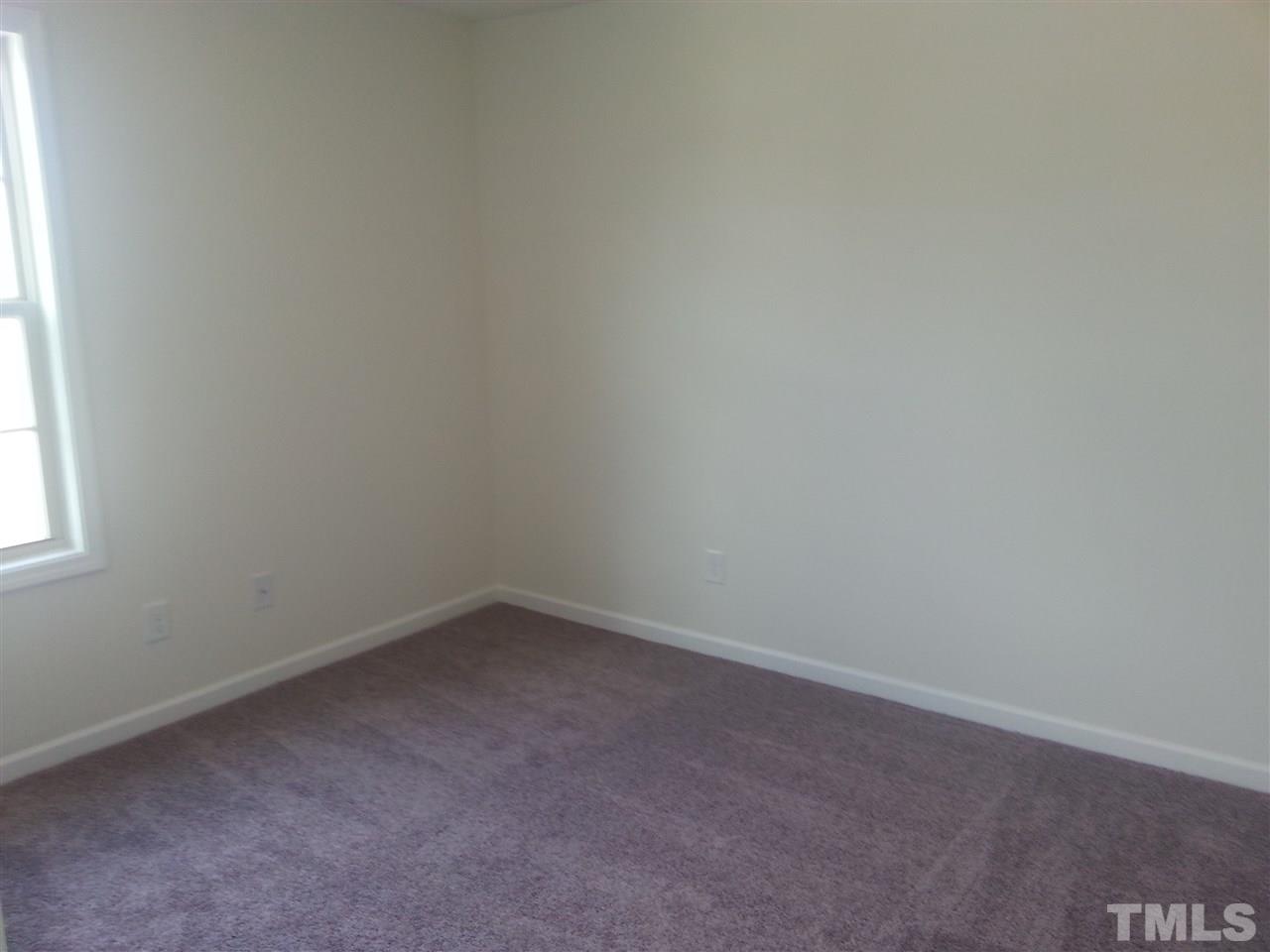 7524 Channery Way Raleigh, NC 27616 - Photo 7 of 25 a room that has a window in it