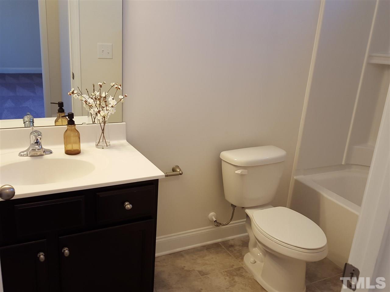 7524 Channery Way Raleigh, NC 27616 - Photo 8 of 25 a bathroom with a sink toilet and mirror