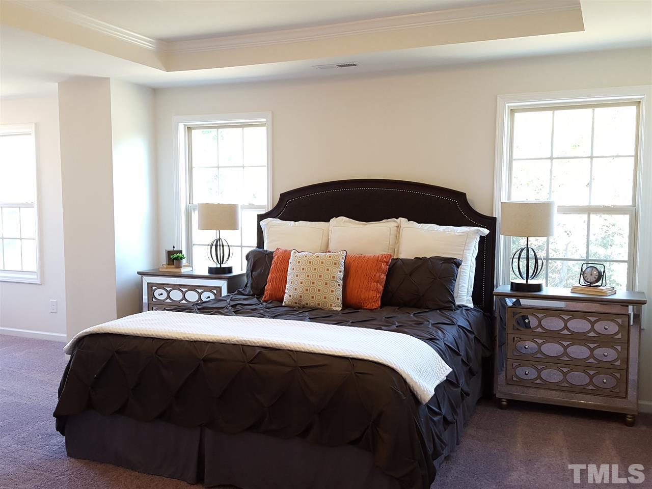 7524 Channery Way Raleigh, NC 27616 - Photo 10 of 25 a bedroom with a bed a dresser and a window