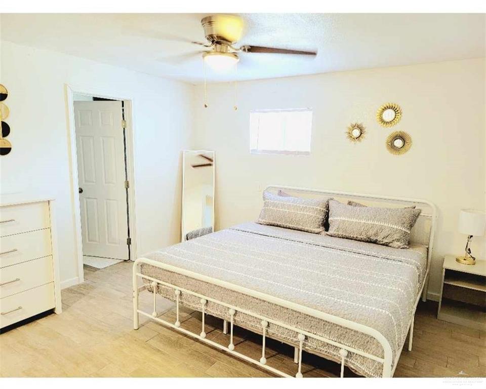 906 East Van Week Street Edinburg, TX 78541 - Photo 11 of 19 a bedroom with a bed and a dresser
