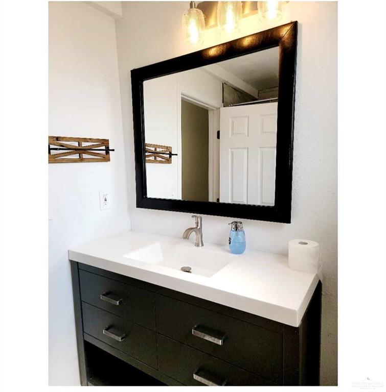 906 East Van Week Street Edinburg, TX 78541 - Photo 14 of 19 a bathroom with a sink and a mirror