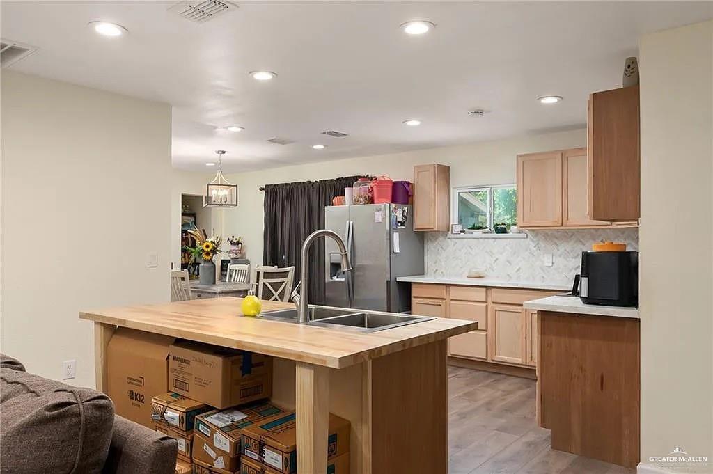 906 East Van Week Street Edinburg, TX 78541 - Photo 18 of 19 a kitchen with granite countertop a sink and cabinets