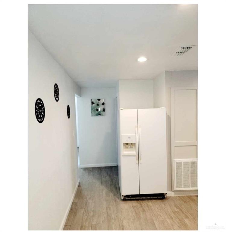 906 East Van Week Street Edinburg, TX 78541 - Photo 10 of 19 a view of a kitchen with a refrigerator and white wall