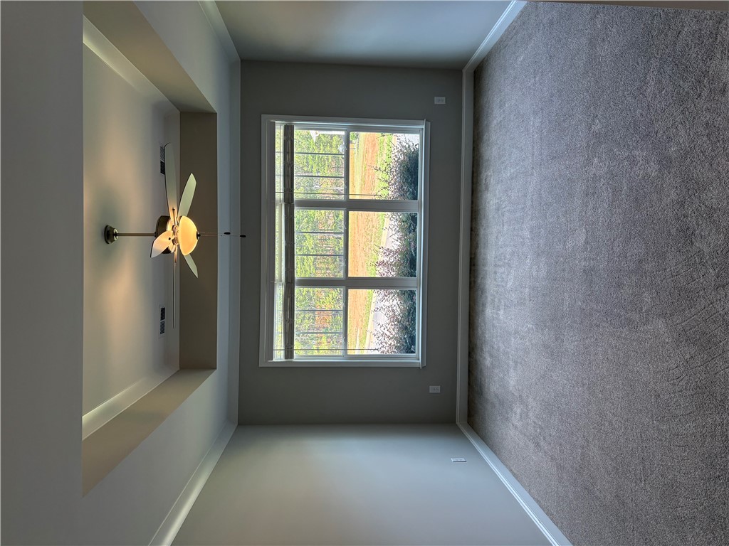 240 Meridian Way Seneca, SC 29672 - Photo 7 of 19 A well-lit bedroom with plush carpeting and a modern ceiling fan, offering tranquil outdoor views.