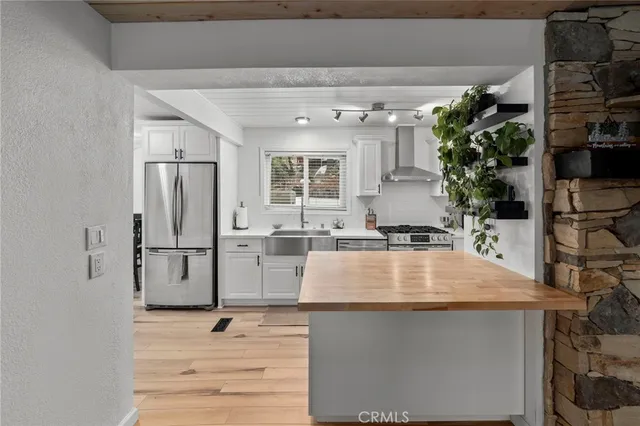 a room with kitchen island a counter top space and wooden floor
